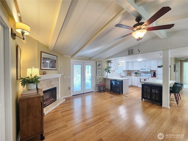 19009 99th Avenue Ct E, Puyallup, WA 98375 - kitchen with white appliances, light countertops, white cabinets, light wood finished floors, and a sink