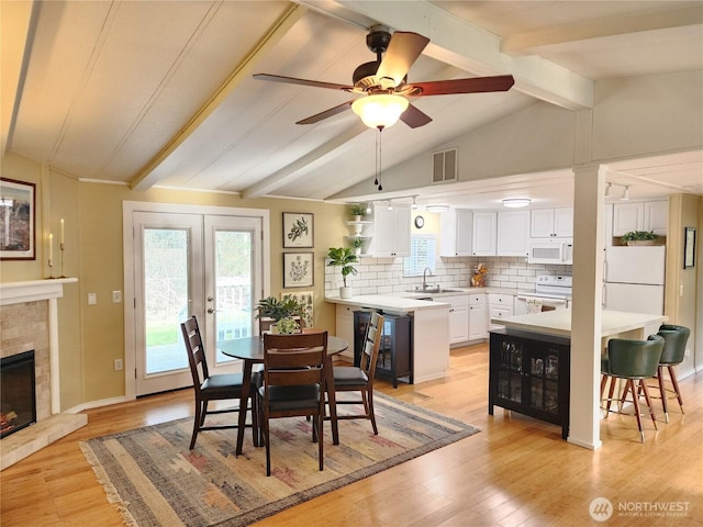 19009 99th Avenue Ct E, Puyallup, WA 98375 - dining room featuring plenty of natural light, light wood finished floors, ceiling fan, and a glass covered fireplace