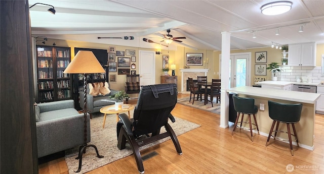 19009 99th Avenue Ct E, Puyallup, WA 98375 - living room featuring light wood finished floors, a ceiling fan, and a fireplace