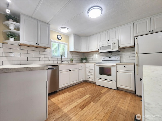 19009 99th Avenue Ct E, Puyallup, WA 98375 - kitchen featuring white appliances, white cabinets, decorative backsplash, and light wood-style flooring