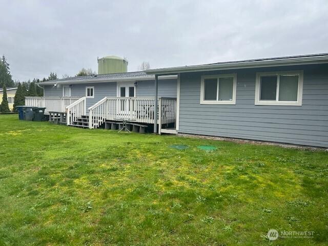 19009 99th Avenue Ct E, Puyallup, WA 98375 - rear view of house with a deck and a yard