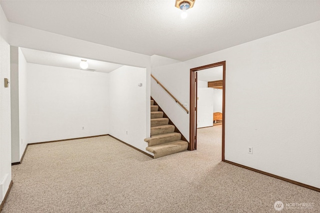 finished below grade area with carpet, stairs, and baseboards