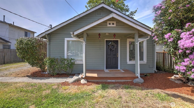 bungalow-style house featuring fence and a porch