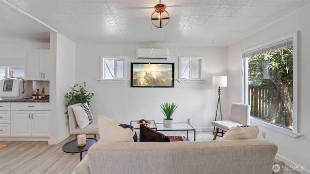 living area featuring an AC wall unit, light wood-type flooring, and baseboards