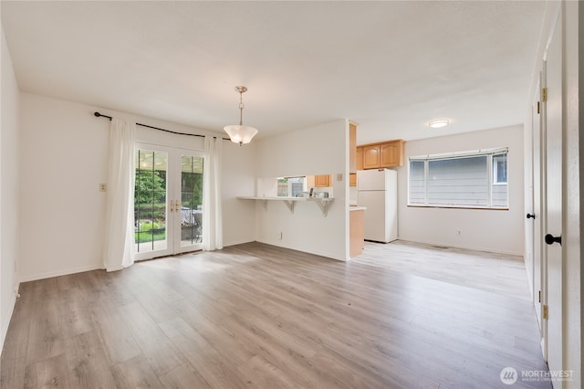 605 W Euclid Ave, Shelton, WA 98584 - unfurnished living room featuring light wood-style flooring, french doors, and baseboards