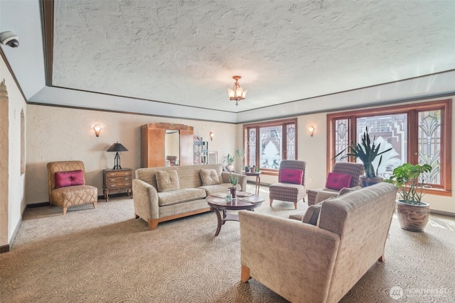 living area with light colored carpet, a textured ceiling, and baseboards