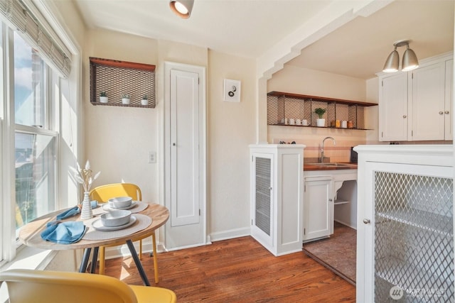 dining space with wood finished floors