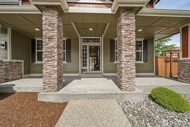 13809 172nd Pl E, Puyallup, WA 98374 - property entrance featuring covered porch, stone siding, and fence