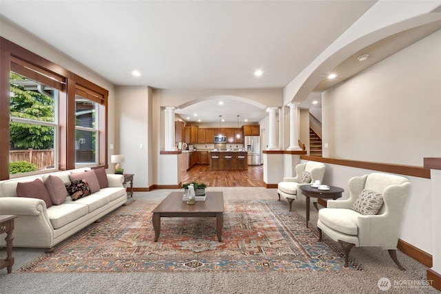 13809 172nd Pl E, Puyallup, WA 98374 - living area with ornate columns, arched walkways, baseboards, recessed lighting, and light wood-type flooring
