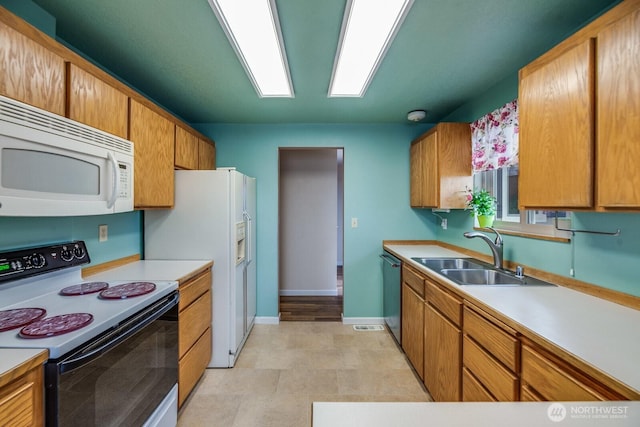 1068 Vista Del Monte, Camano Island, WA 98282 - kitchen featuring white appliances, a sink, baseboards, and light countertops