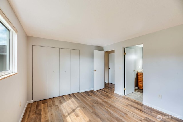 1068 Vista Del Monte, Camano Island, WA 98282 - unfurnished bedroom featuring light wood-type flooring, baseboards, a closet, and ensuite bath
