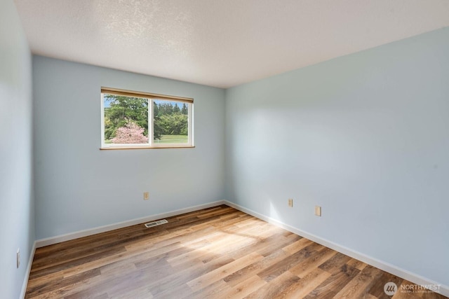 1068 Vista Del Monte, Camano Island, WA 98282 - spare room featuring wood finished floors and baseboards