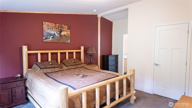 carpeted bedroom with vaulted ceiling