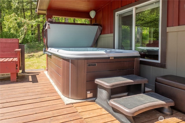 wooden deck with a hot tub