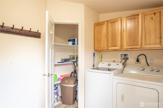washroom with cabinet space and washing machine and clothes dryer