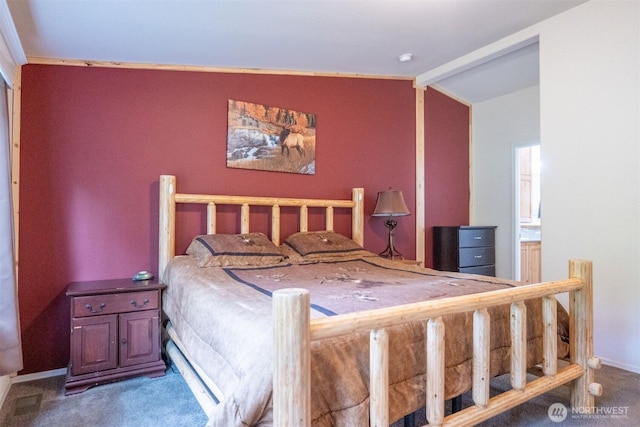 bedroom with carpet floors, lofted ceiling, and baseboards