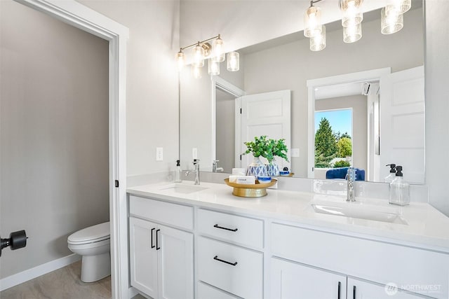 2900 NE 5th Pl, Renton, WA 98056 - full bath featuring toilet, double vanity, and baseboards