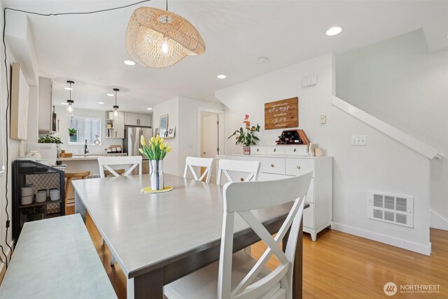 dining space featuring recessed lighting, light wood finished floors, and baseboards