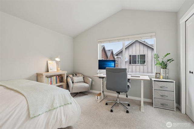 carpeted bedroom featuring lofted ceiling and baseboards