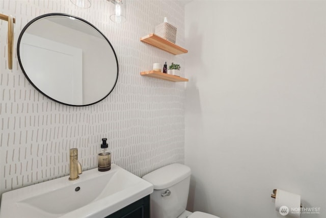 half bathroom with toilet and vanity
