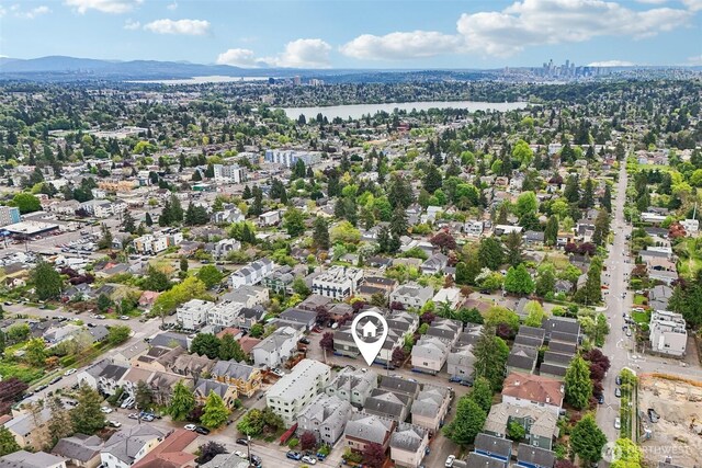 aerial view of property's location with a nearby body of water and nearby urban area