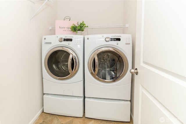 laundry room featuring washer and clothes dryer and baseboards