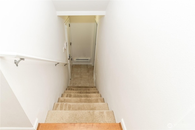 staircase with baseboard heating and tile patterned flooring