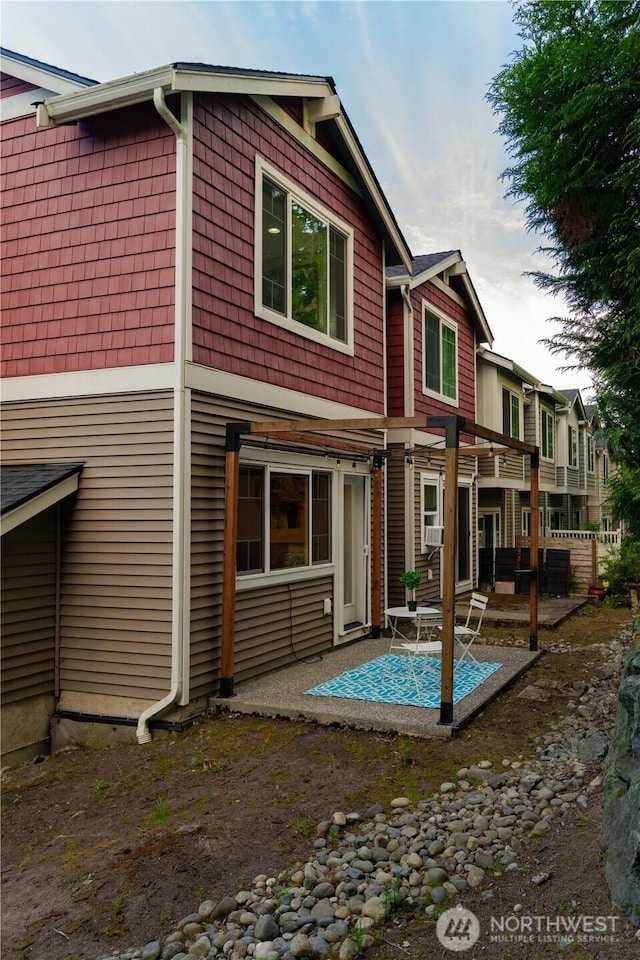 rear view of property featuring a patio area