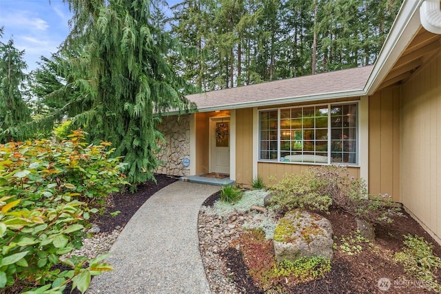 2124 213th Street Ct E, Spanaway, WA 98387 - property entrance with stone siding and roof with shingles
