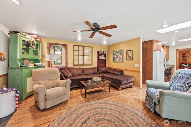 2124 213th Street Ct E, Spanaway, WA 98387 - living area with ceiling fan, light wood-style flooring, a skylight, wainscoting, and recessed lighting