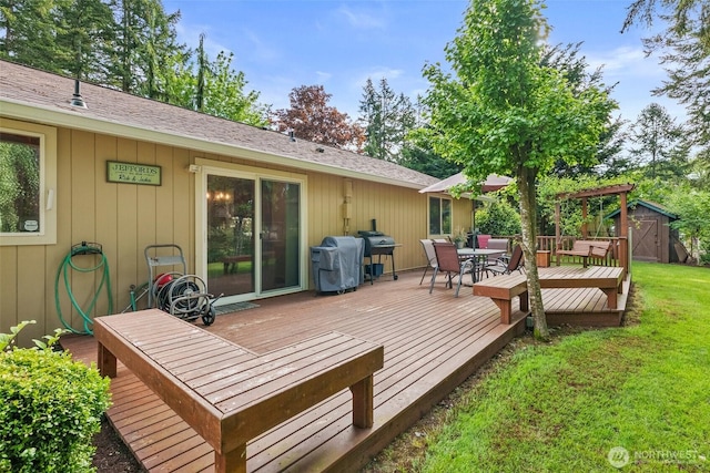 2124 213th Street Ct E, Spanaway, WA 98387 - wooden terrace with a storage shed, an outbuilding, outdoor dining space, and a lawn