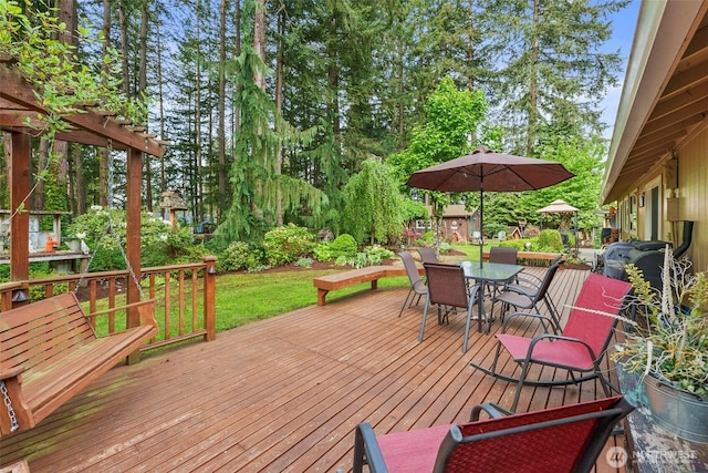 2124 213th Street Ct E, Spanaway, WA 98387 - wooden terrace featuring outdoor dining area, a shed, and an outbuilding