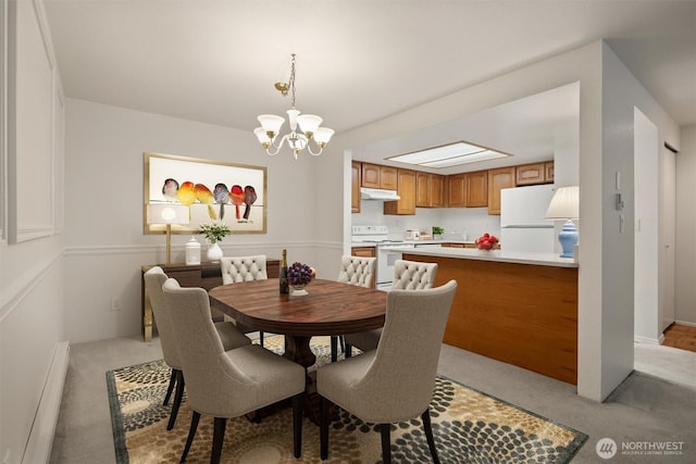 4106 Factoria Blvd SE Unit 216, Bellevue, WA 98006 - dining room with a baseboard radiator, light carpet, and a chandelier