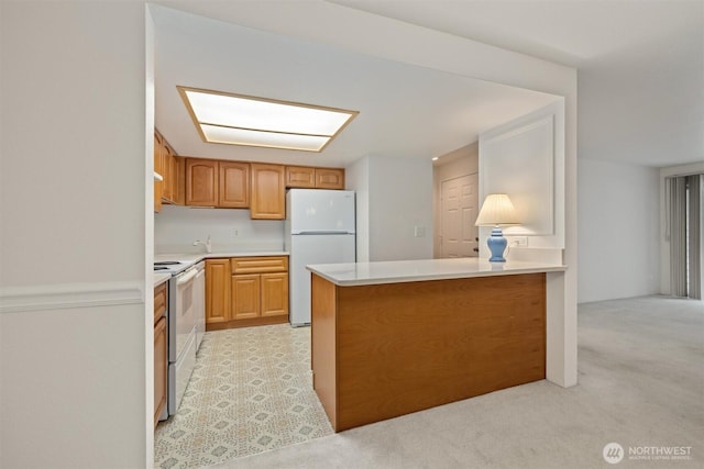 4106 Factoria Blvd SE Unit 216, Bellevue, WA 98006 - kitchen featuring white appliances, light countertops, a peninsula, and light carpet