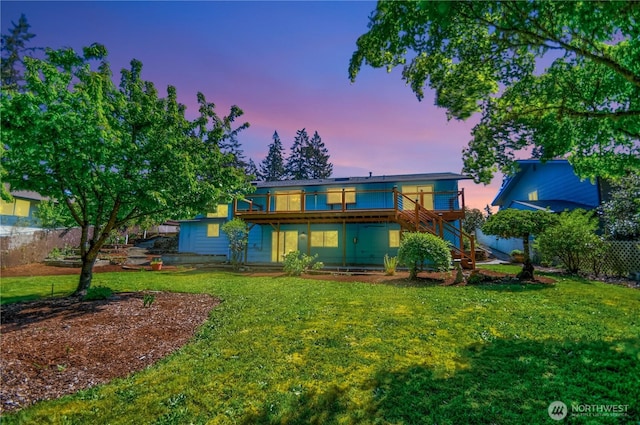 10910 114th Ave SW, Tacoma, WA 98498 - back of house at dusk with a wooden deck and stairs