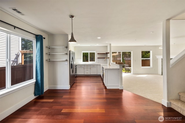 kitchen featuring open floor plan, plenty of natural light, open shelves, and recessed lighting