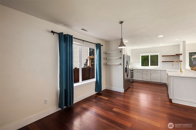 kitchen with open shelves, light countertops, dark wood finished floors, stainless steel fridge with ice dispenser, and recessed lighting