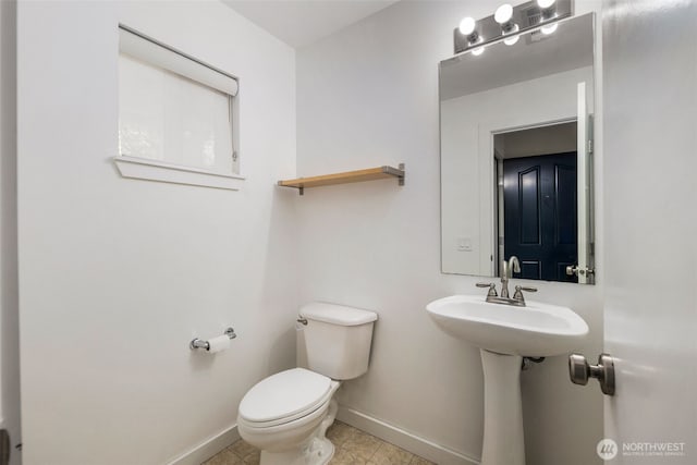 bathroom featuring baseboards, toilet, and tile patterned floors
