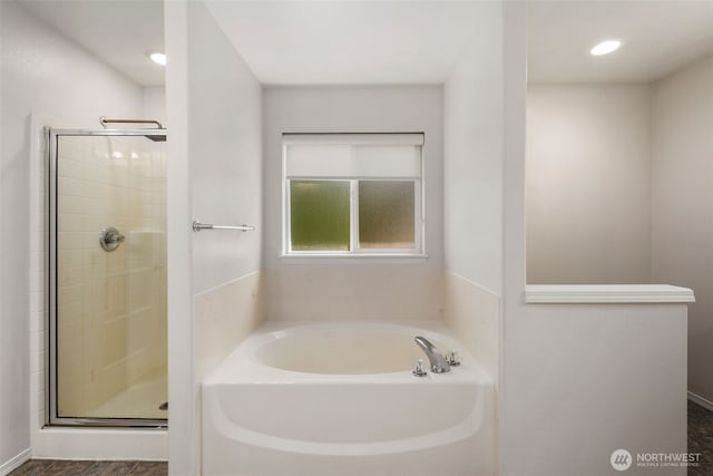 full bath with a shower stall and a garden tub