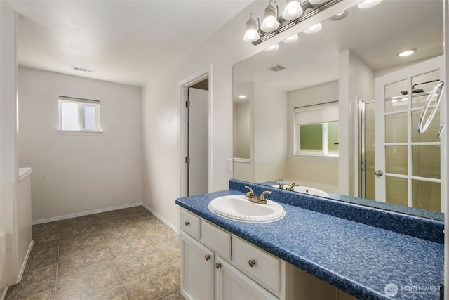 full bathroom with a shower stall, vanity, and baseboards