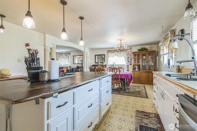 12623 Douglas Rd, Yakima, WA 98908 - kitchen featuring ornate columns, white cabinetry, and dark countertops