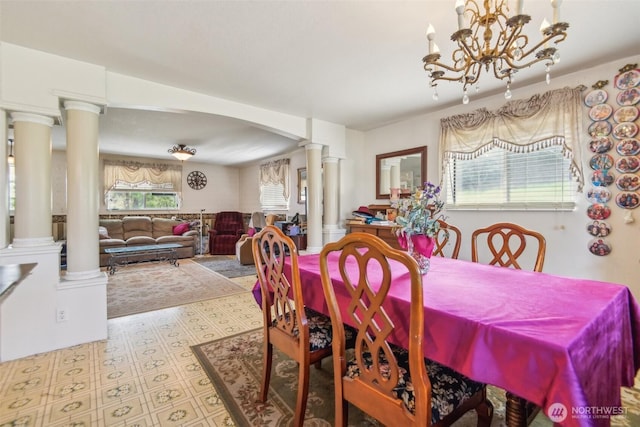 12623 Douglas Rd, Yakima, WA 98908 - dining room featuring ornate columns, a chandelier, and arched walkways