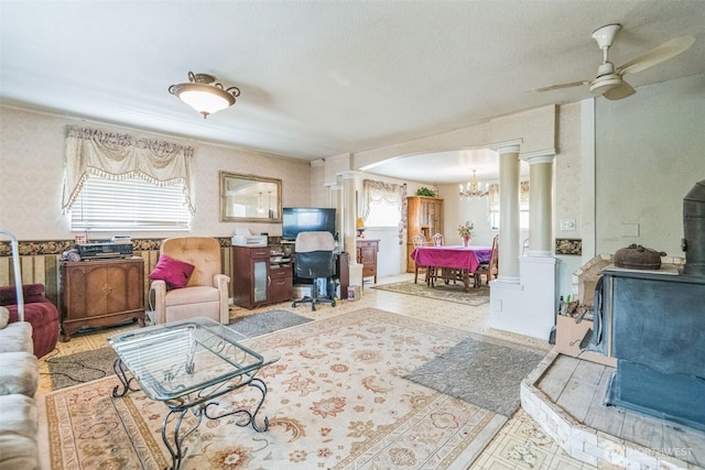12623 Douglas Rd, Yakima, WA 98908 - living room with decorative columns, a ceiling fan, arched walkways, a chandelier, and wallpapered walls