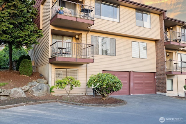 view of building exterior featuring a garage and driveway