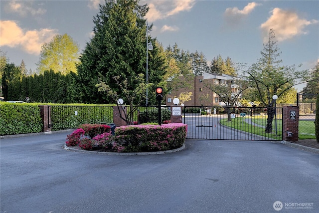 10713 Glen Acres Dr S, Seattle, WA 98168 - view of asphalt street featuring curbs, a gate, street lights, and a gated entry