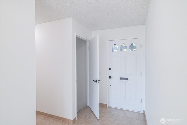 10713 Glen Acres Dr S, Seattle, WA 98168 - entryway with light tile patterned flooring and a textured ceiling