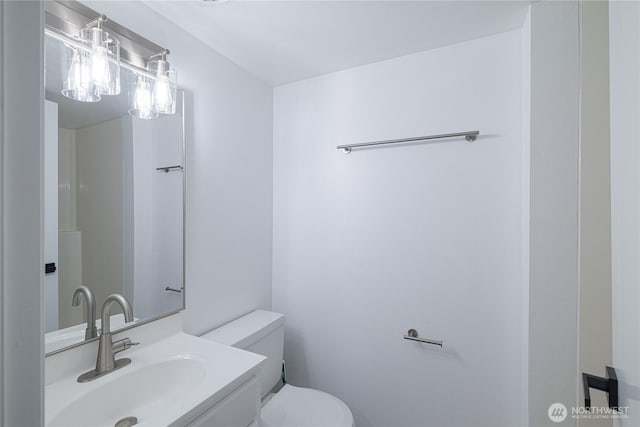 bathroom with toilet and vanity