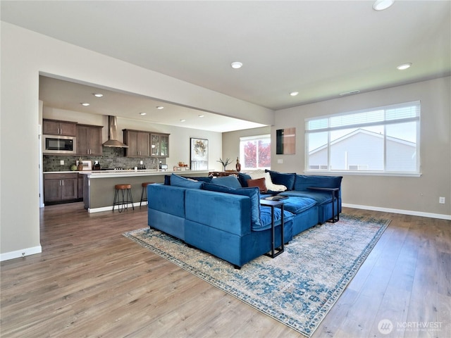 9932 15th Pl SE, Lake Stevens, WA 98258 - living area with light wood-style flooring, baseboards, and recessed lighting