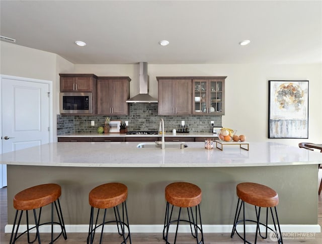 9932 15th Pl SE, Lake Stevens, WA 98258 - kitchen with wall chimney range hood, a sink, stainless steel appliances, backsplash, and recessed lighting
