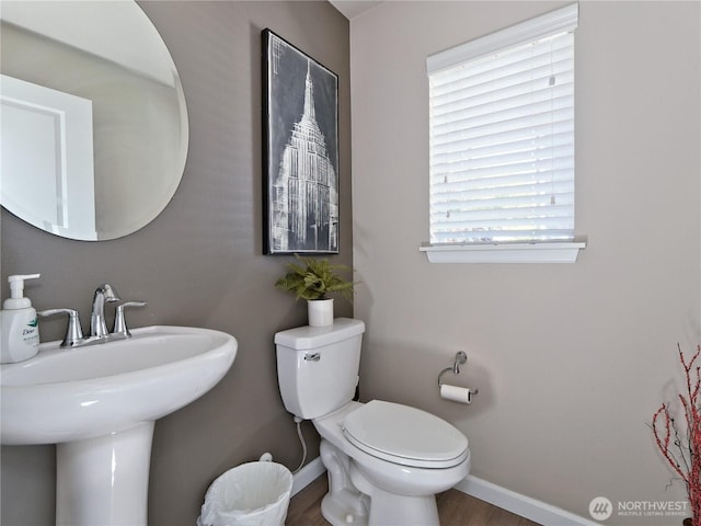 9932 15th Pl SE, Lake Stevens, WA 98258 - half bathroom with baseboards, toilet, a sink, and wood finished floors